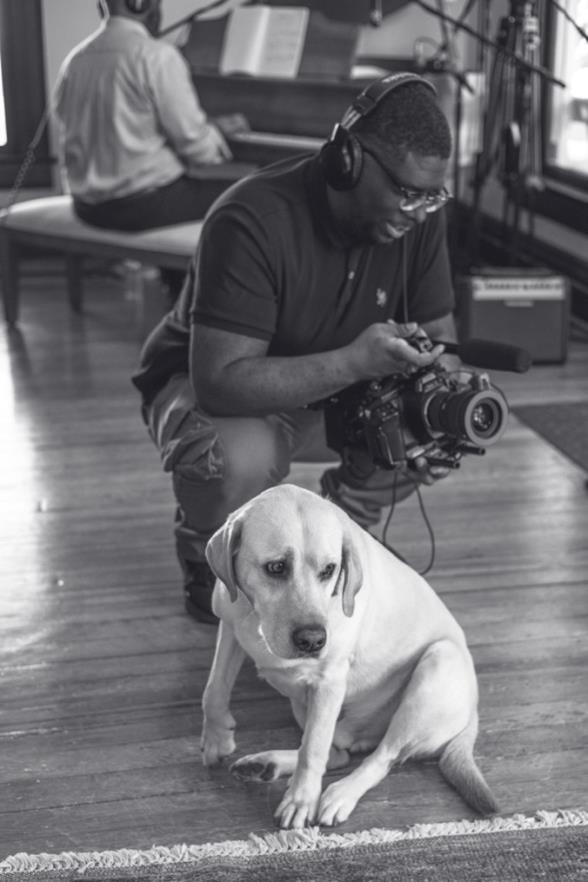 Filmmaker with dog during recording sessions
